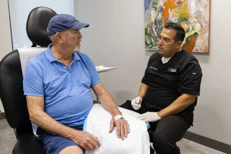 Dr. Paz examining a patient's skin
