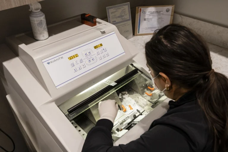 A lab technician preparing Mohs slides at the cryostat