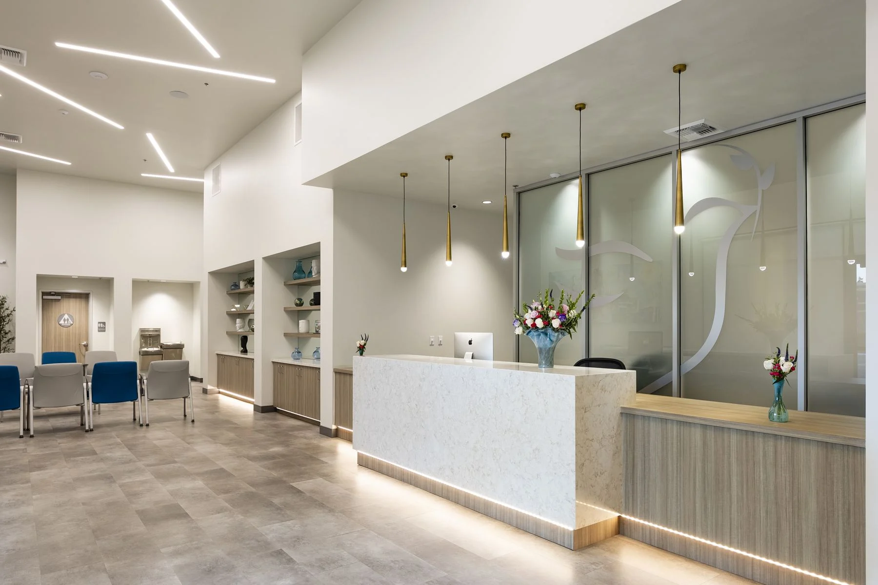 Fresno check-in desk and waiting area, gold pendant lights