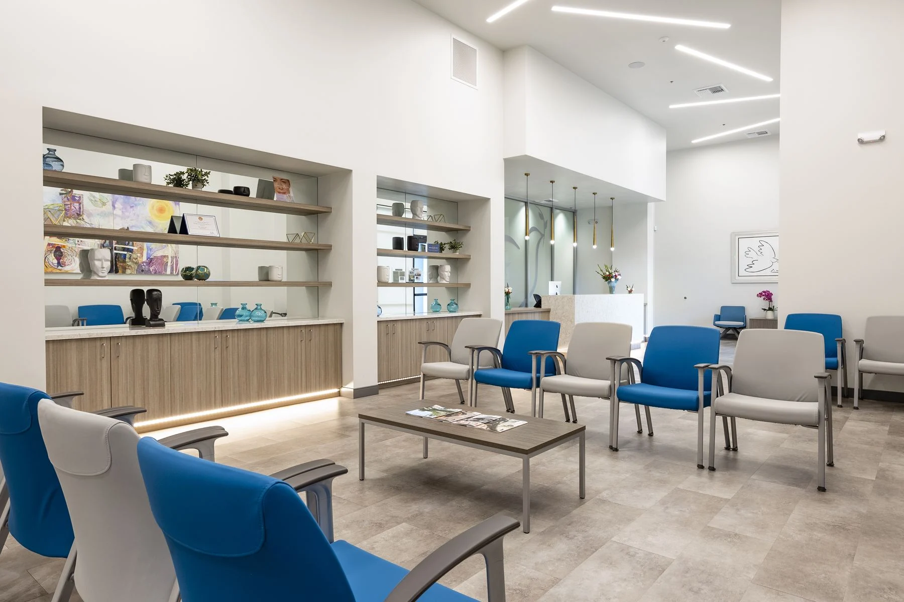 The Fresno waiting room with blue chairs and display shelves