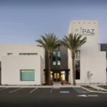 Visalia office at dusk, front with palms and the PAZ tower