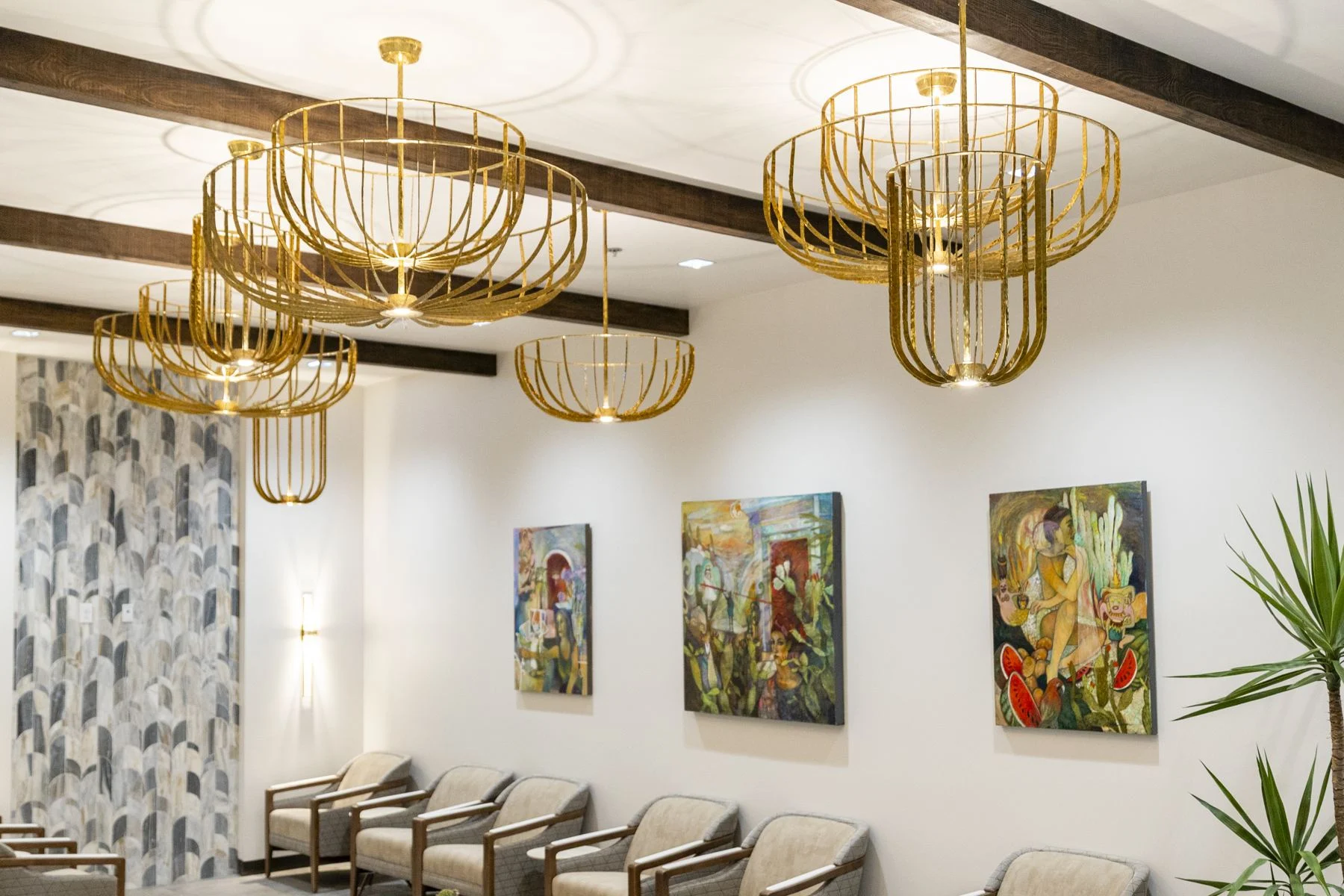 Visalia lobby seating under gold chandeliers, with art on the walls