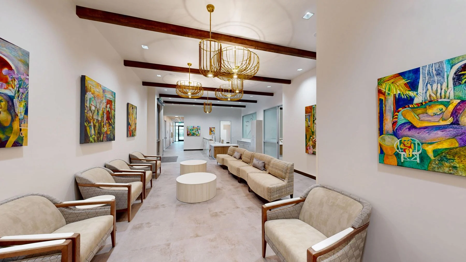The long Visalia waiting room, lined with armchairs and colorful local paintings