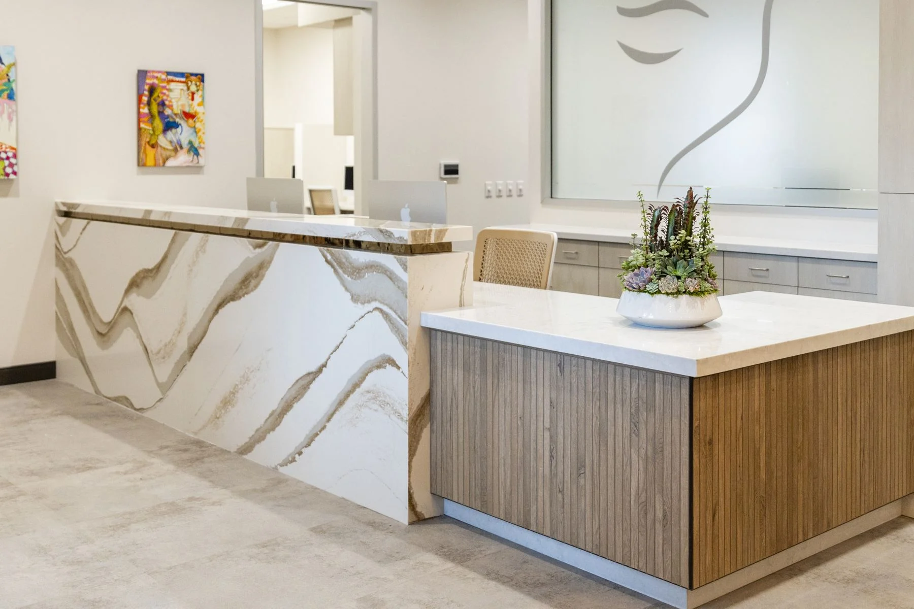 The Visalia reception desk in veined quartz and wood